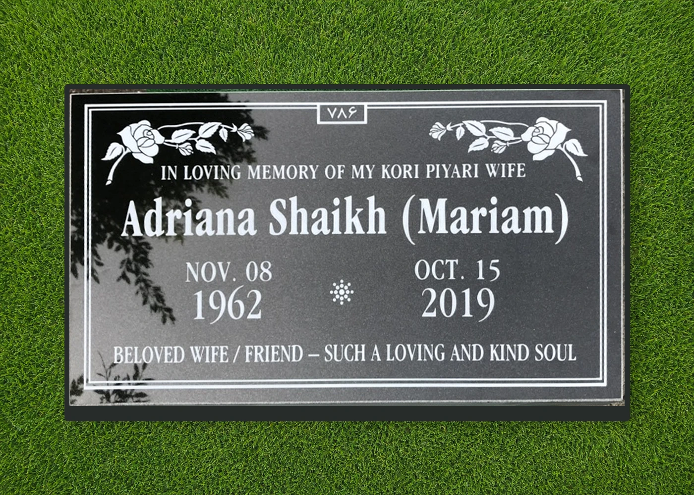 Black granite 28 by 16 inch flat marker with floral engraving