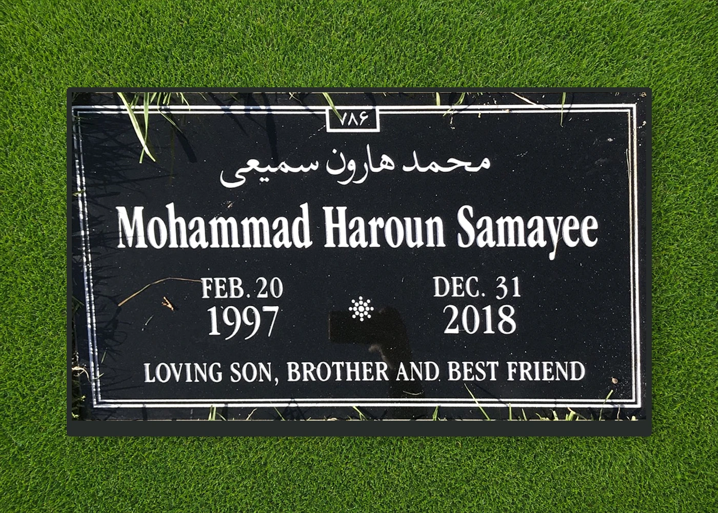Black granite 28 by 16 inch marker with Arabic and English lettering